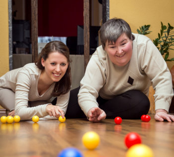 young girl and caregiver playing