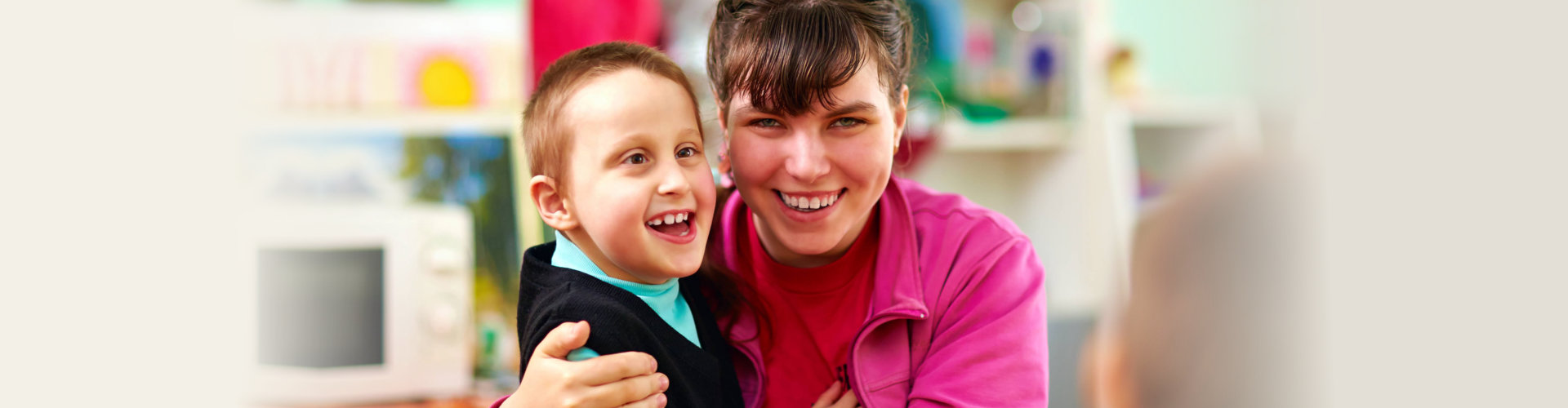 caregiver and a child smiling